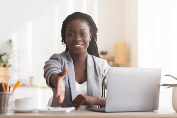 Female HR manager extending hand for handshake after successful job interview