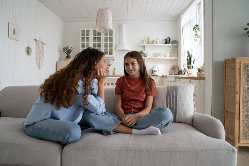 teenage daughter talking with mother